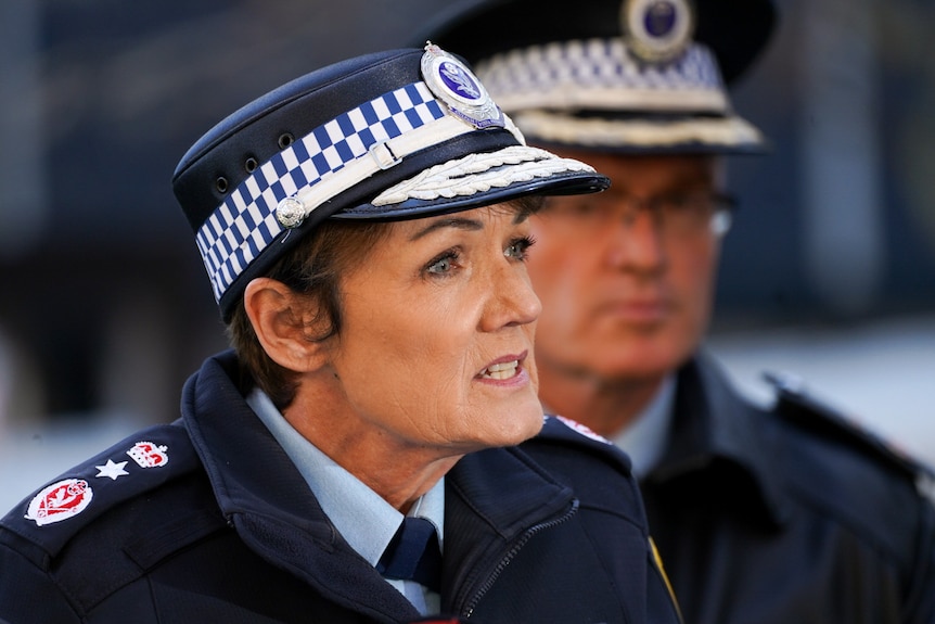 A woman wearing a police hat