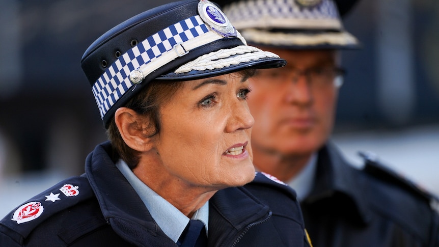 A woman wearing a police hat