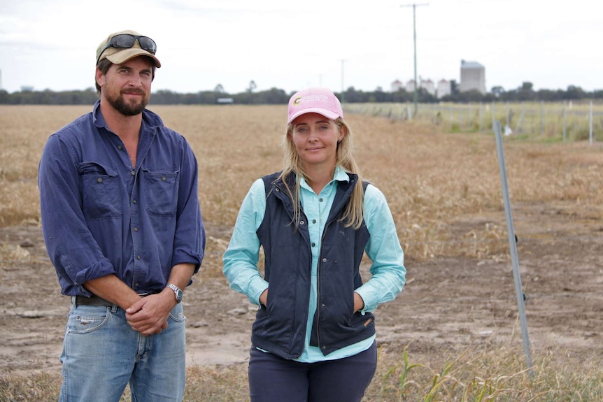 Daniel and Melissa Wegener stand in a field on their Brigalow property.