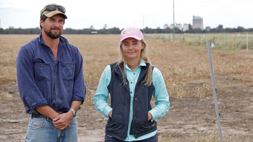 Daniel and Melissa Wegener stand in a field on their Brigalow property.