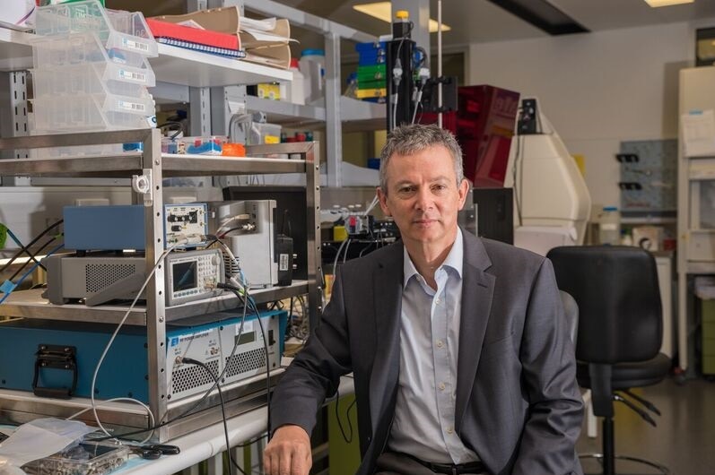 Professor Jugen Gotz sitting in a lab.