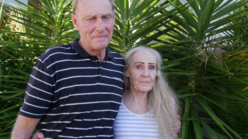 brother and sister have their arms around each other staring into the camera