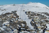 snow on mountain with buildings