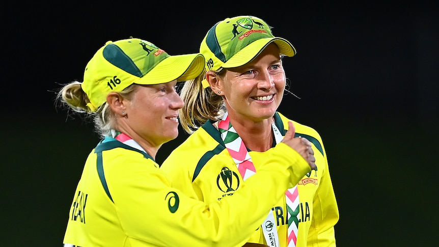 Meg Lanning and Alyssa Healy stand and smile