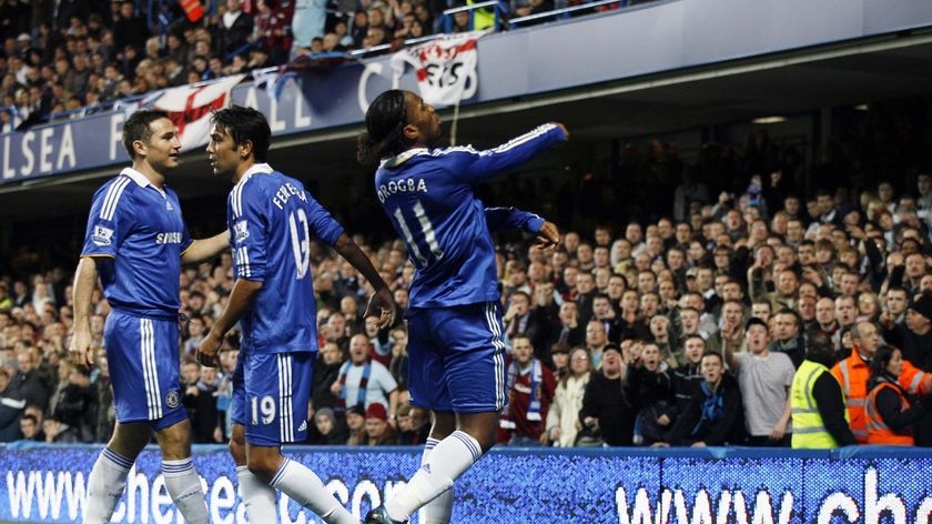 Chelsea striker Didier Drogba, right, throws a coin back at the Burnley fans