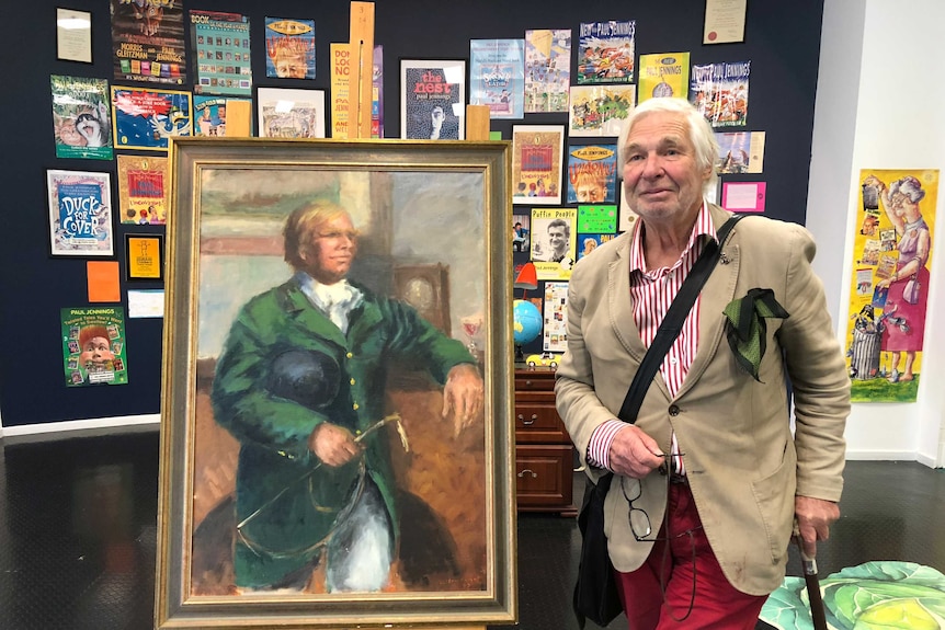 Victor Caulfield has a penchant for portraits, of himself. He poses with one of his paintings at the Warrnambool Art Gallery.