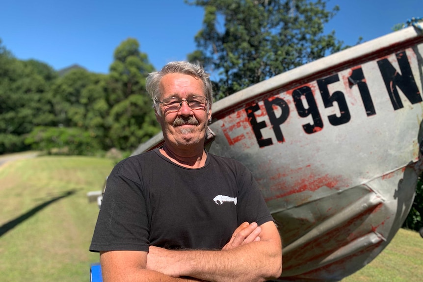 Small boat owner Ian Townsend in front of his little tinny