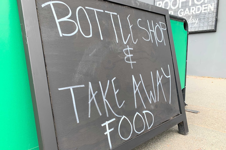 A chalk sign reads 'bottle shop and take away food'.