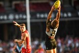 Port Adelaide's Hamish Hartlett (R) marks against the Sydney Swans at the SCG on April 1, 2018.  