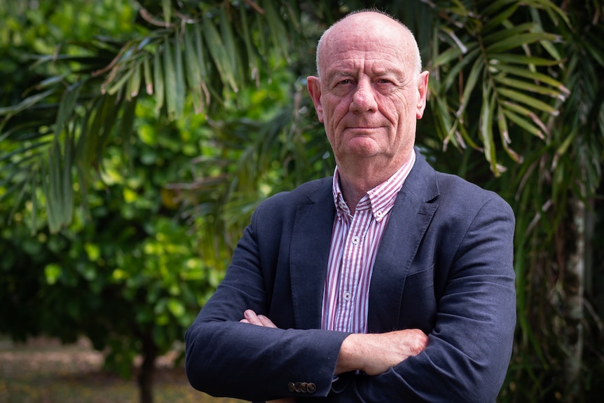 Alliance for Gambling chief advocate Tim Costello looking serious with his arms folded and trees behind him