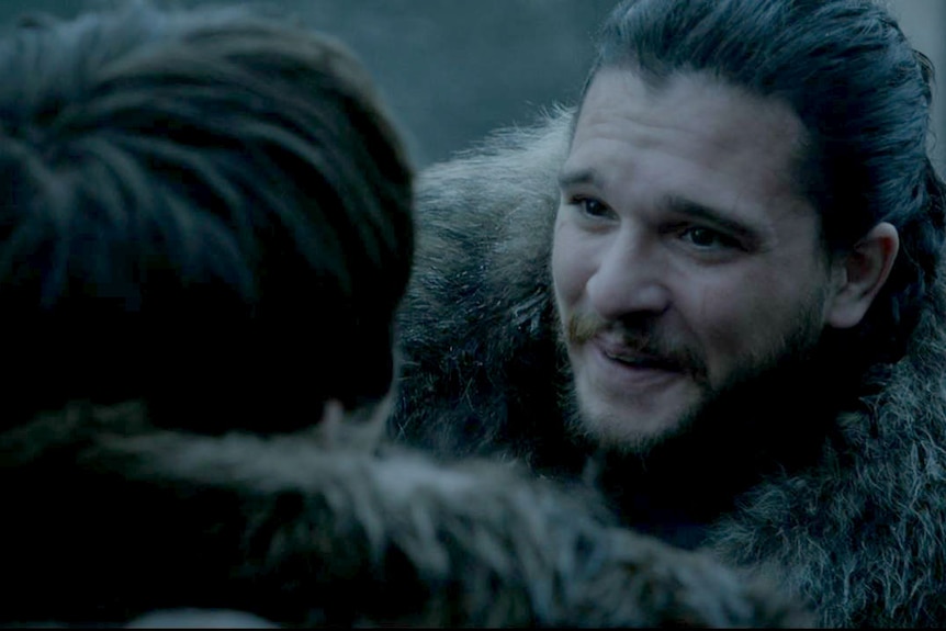 Jon smiles after embracing Bran.