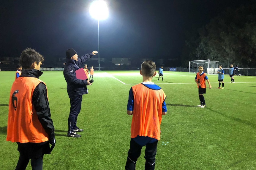 Sydney FC academy leader Kelly Cross puts some of his young charges through their paces.