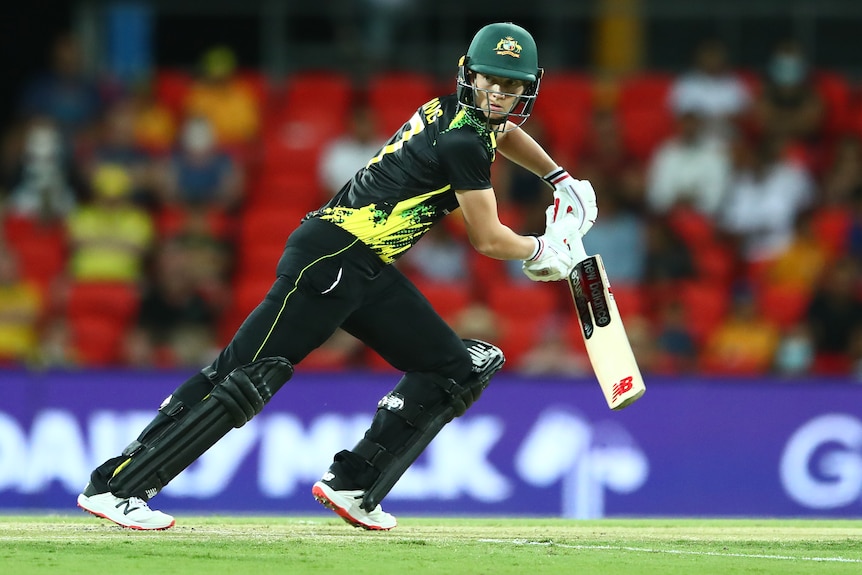 An Australian female cricketer plays a shot against India.