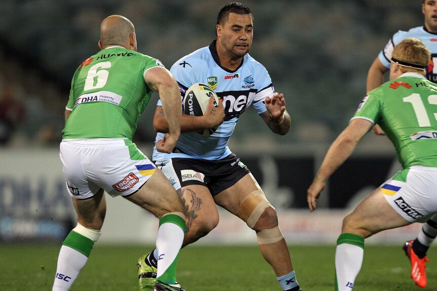 Cronulla's Andrew Fifita gets tackled by Canberra defence