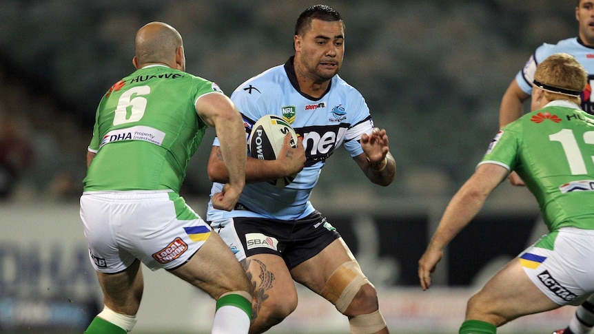 Cronulla's Andrew Fifita gets tackled by Canberra defence