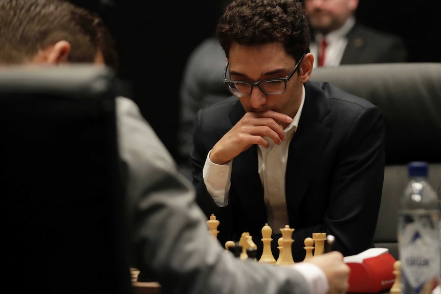 Fabiano Caruana studies the board during the world chess championship