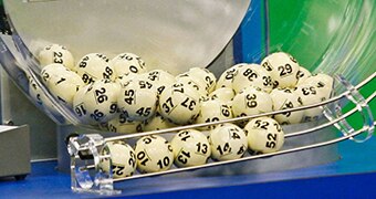 Lottery balls fall into a chute.