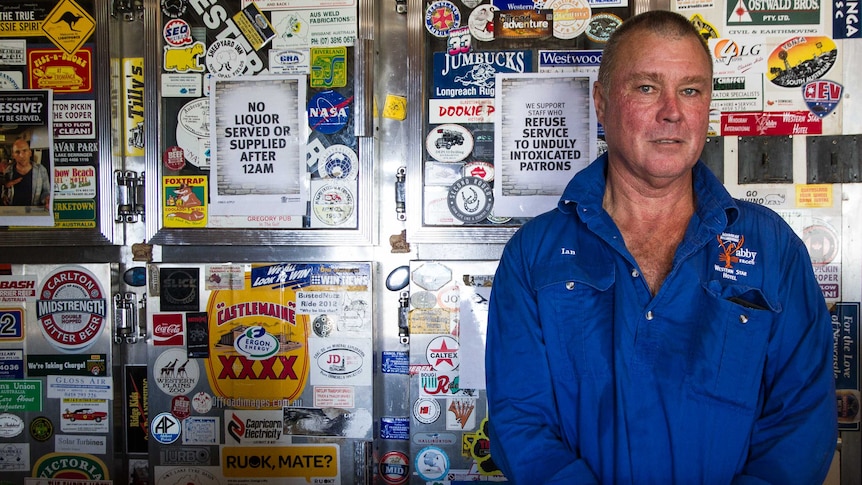 Windorah publican Ian Simpson standing in front of the fridge in south-west Queensland.