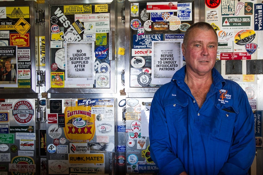 Windorah publican Ian Simpson standing in front of the fridge.