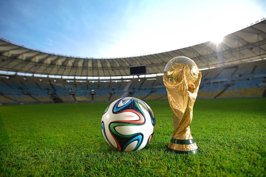 The Brazuca ball and World Cup trophy