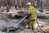 A firefighter mops up at Northcliffe