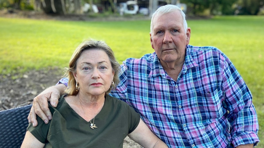 a man sitting with his arm around a woman