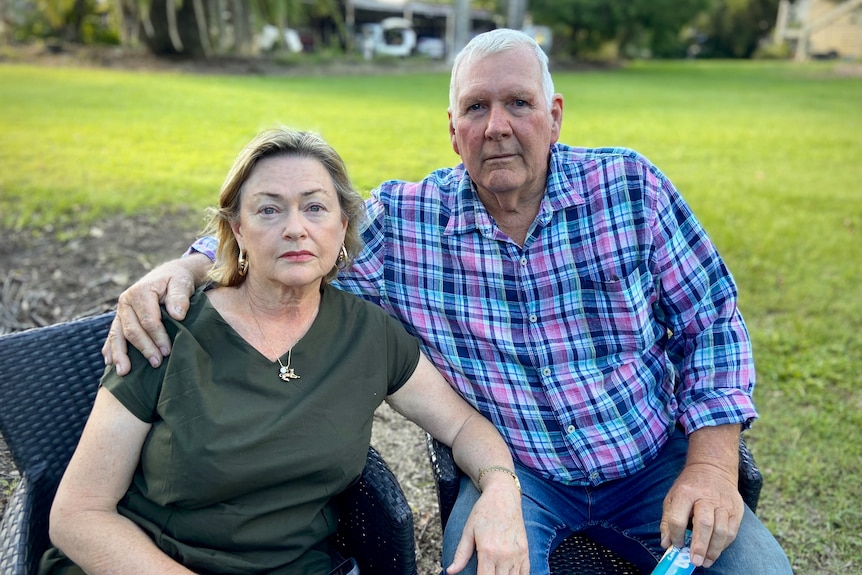 a man sitting with his arm around a woman