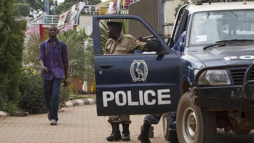 Ugandan police patrol a shopping centre after terror cell discovery