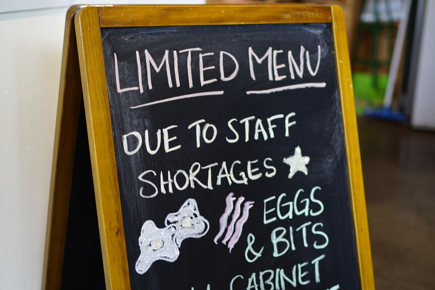 A frame with chalk writing informing about staff shortages.