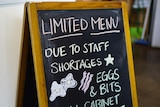 A frame with chalk writing informing about staff shortages