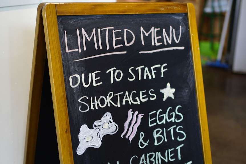 A frame with chalk writing informing about staff shortages