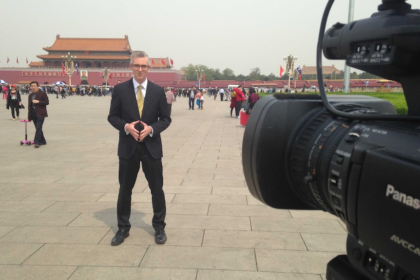 Speers standing in front of camera in Tiananmen Square in Beijing.