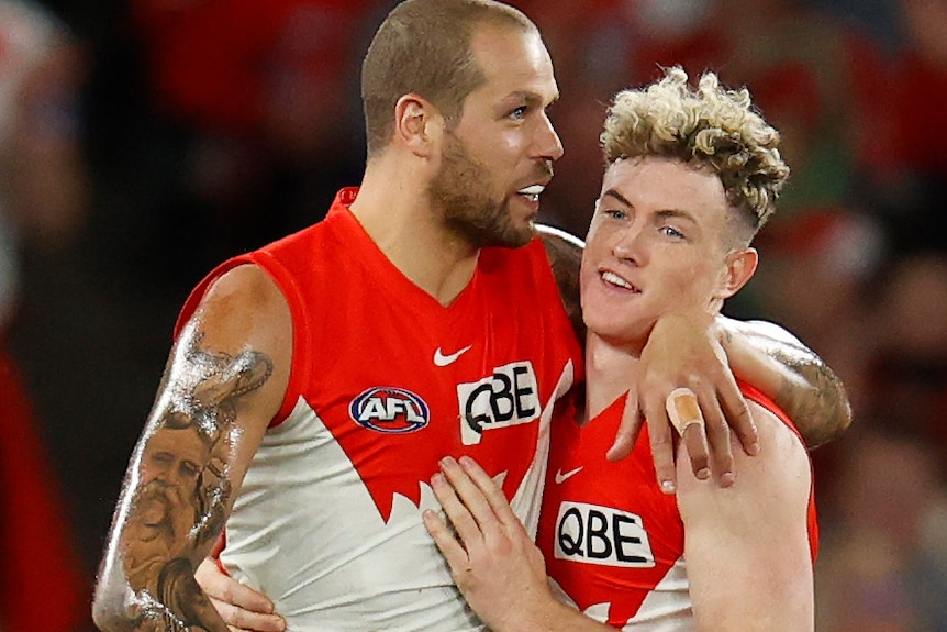 Lance Franklin puts his arm around Chad Warner