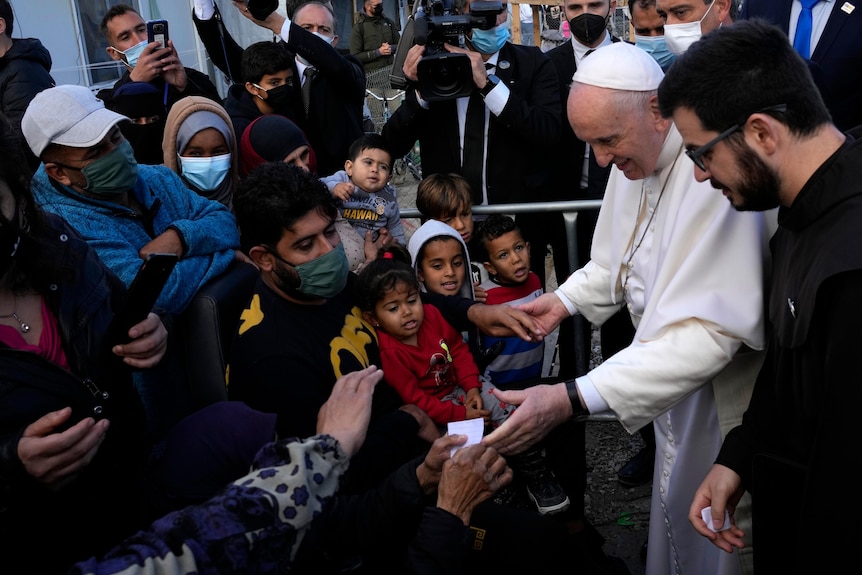 Pope Francis greets children at camp.