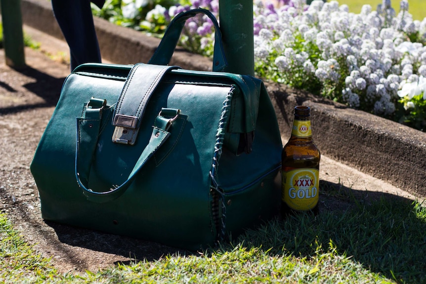 Bowls balls bag and a bottle of beer.