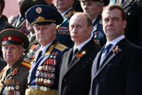 Russian President Dmitry Medvedev and Prime Minister Vladimir Putin attend a Victory Day Parade