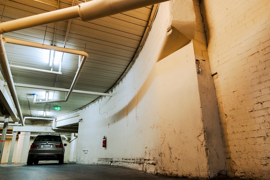 A curved wall in an underground carpark.