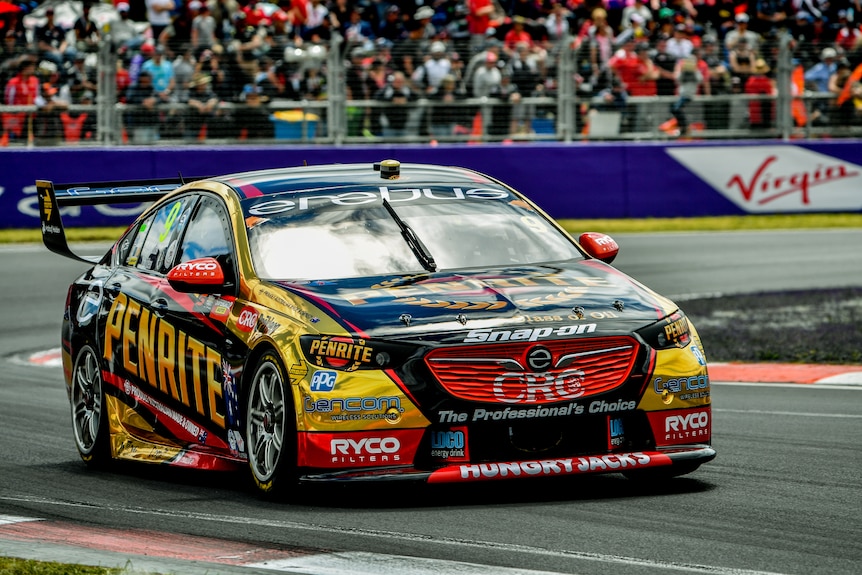 A Holden racing car goes around a corner