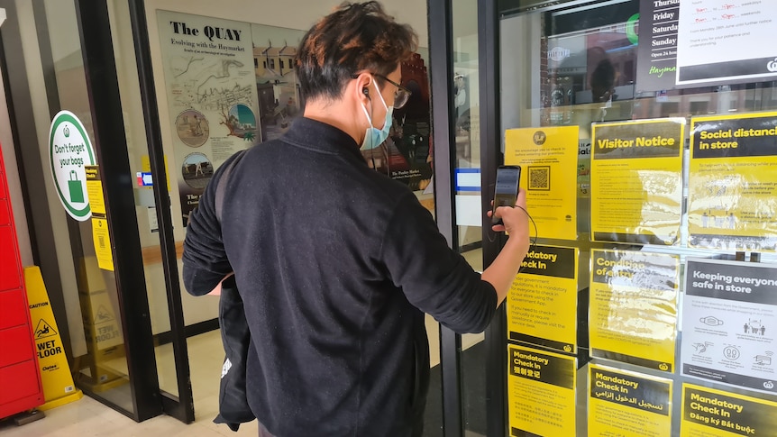 a man using a phone to check in