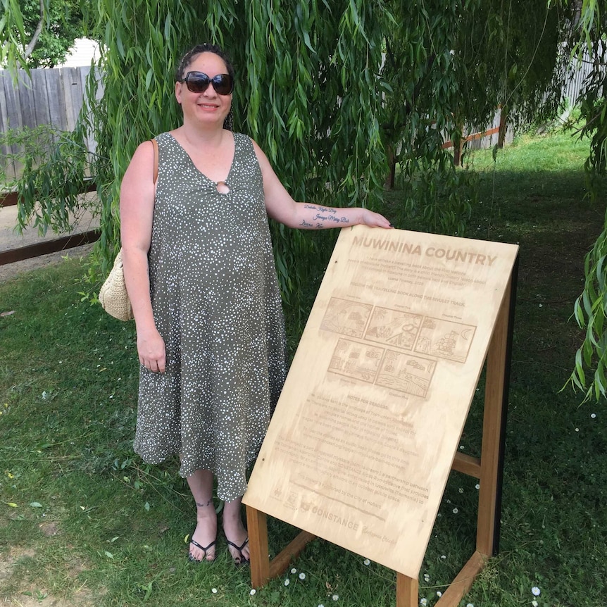 Luana Towney with the first board in her "Muwinina Country" artwork