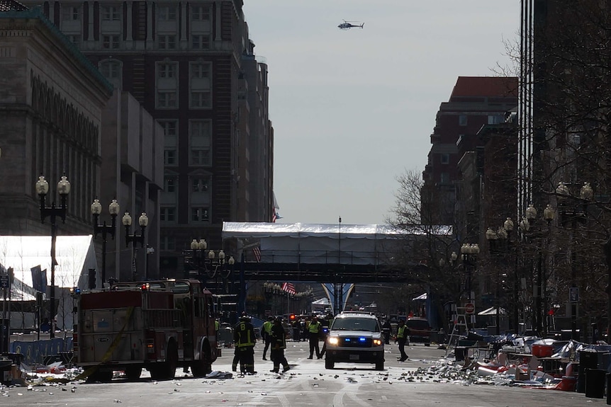 Helicopters fly overhead as emergency crews continue working in Boston.
