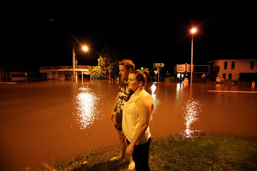 Residents take a look at the flooded streets of Gundagai on Monday.