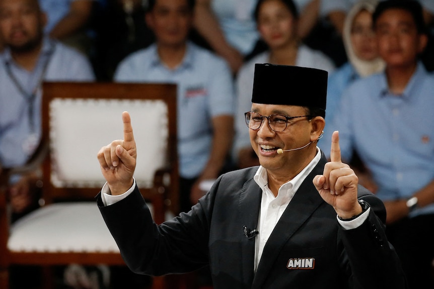 Former Jakarta Governor and presidential candidate Anies Baswedan gestures during a televised debate.