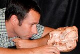 Dr Bastien Llamas with skull of short-faced kangaroo