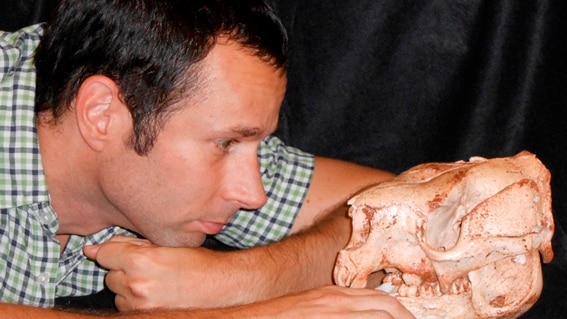 Dr Bastien Llamas with skull of short-faced kangaroo