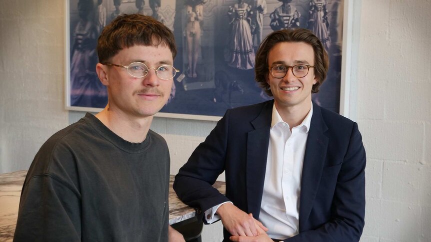 Tim Bates and Max Dowzer-Strode sit at a large table