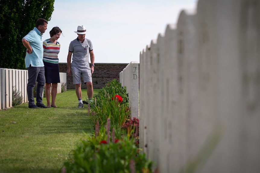 Matt Benson (l), Louise Stranks (c) and Andrew Benson (r) at the grave of their great uncle near Hamel