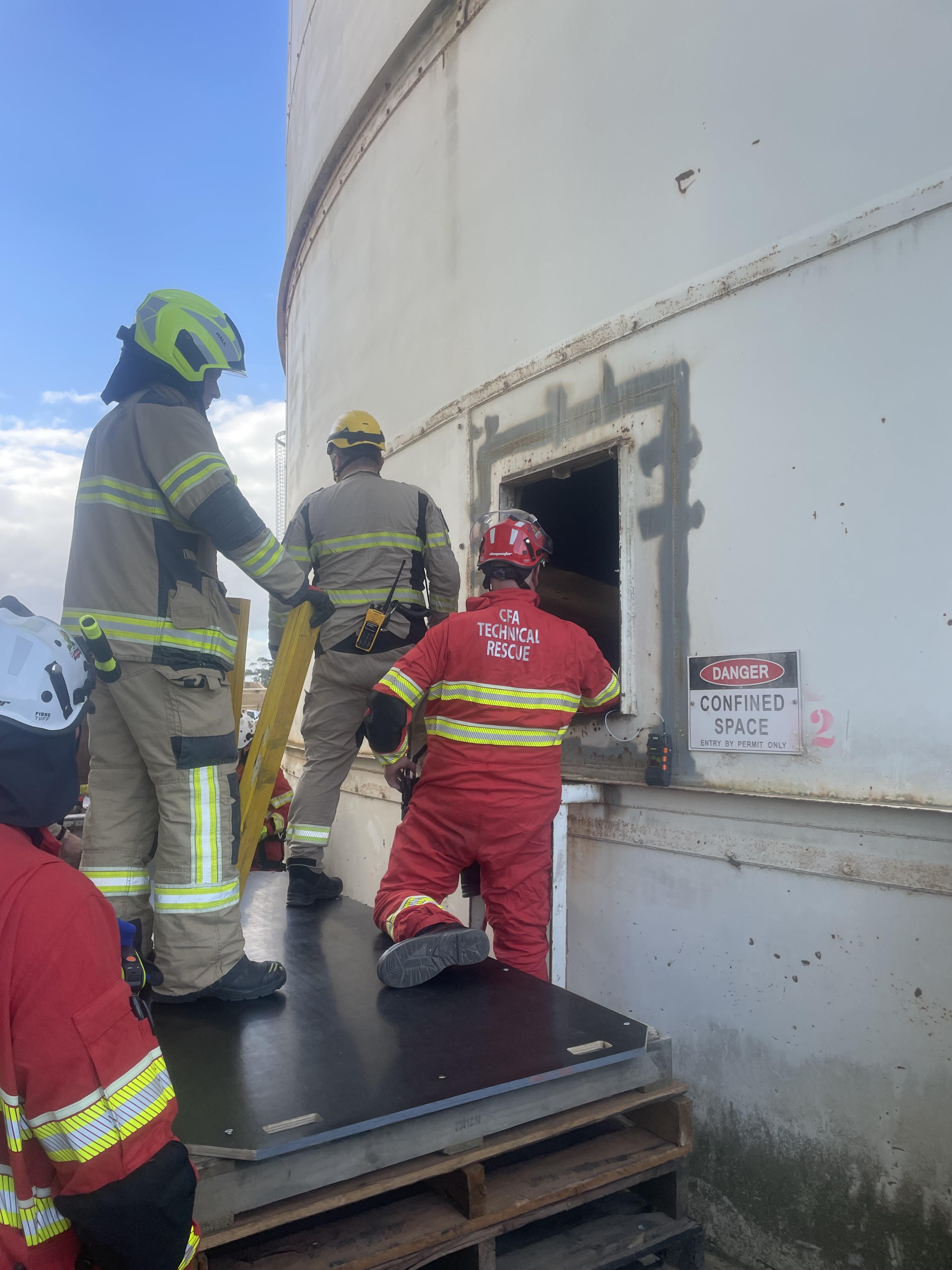 Emergency crews standing at the entrance of a grain silo.