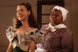 Hattie McDaniel stands behind Vivian Leigh in a scene from Gone with the Wind.