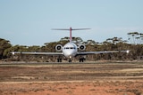 A plane taxis on a runway.  